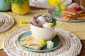 Easter decoration in yellow and white flowered cup