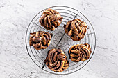 Freshly baked caramel-cinnamon knots on a cake rack