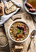 Lentil and potato stew with sausage and bread