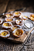 Mini tarts made of puff pastry and sliced apples sprinkled with powdered sugar