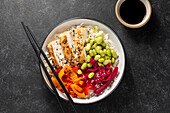 Chicken and pepper poke bowl with edamame and pickled red cabbage