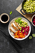 Chicken sweet pepper poke bowl with edamame beans and pickled red cabbage