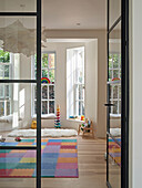 View through glass door to colourful and bright playroom