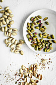Whole and shelled pistachios on a plate