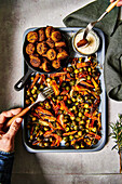 Sweet potato and Brussels sprout traybake with falafal and garlic sauce