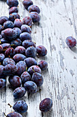 Plums on a shabby chic wooden background