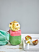 Layered ice cream sundae with spinach ice cream, strawberry ice cream, pineapple ice cream and passion fruit sauce
