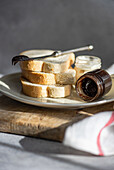 Plate with bread and jars of lemon and chocolate honey