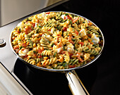 Colourful pasta with cod and prawns