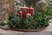 Advent wreath with red winterberry (Ilex verticillata), holly 'Blue Prince' (Ilex meserveae)