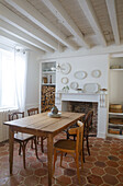 Dining room with wooden table, chairs and brick fireplace