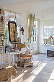 Bright country-style living room with rustic wooden furniture and large windows