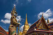 A yaksha guardian statue at the Temple of the Emerald Buddha complex in the Grand Palace grounds in Bangkok, Thailand. A yaksha or yak is a giant guardian spirit in Thai lore.