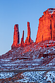 The Three Sisters, sandstone monoliths at the edge of Mitchell Mesa in the Monument Valley Navajo Tribal Park in Arizona.