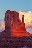 Sunset spotlight on the West Mitten Butte in the Monument Valley Navajo Tribal Park in Arizona.