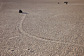Sailing stone & track on the Racetrack Playa in Death Valley National Park in the Mojave Desert, California.
