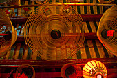 Burning incense coils send prayers to heaven in the Man Mo Temple, a Buddhist temple in Hong Kong, China.