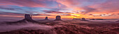 Colorful sunrise with ground fog in the Monument Valley Navajo Tribal Park in Arizona.