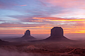 Colorful sunrise with ground fog in the Monument Valley Navajo Tribal Park in Arizona.