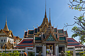 Ornate gateway into the Middle Court of the Grand Palace in Bangkok, Thailand, with the Phra Thinang Dusit Maha Prasat behind.