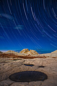 Star trails over the moonlit sandstone in the White Pocket Recreation Area, Vermilion Cliffs National Monument, Arizona.