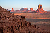 North Window view of the Utah monuments at first light in the Monument Valley Navajo Tribal Park in Arizona. L-R: Elephant Butte (foreground), Setting Hen, Big Indian Chief, Brigham's Tomb, King on the Throne, Castle Butte, Bear and Rabbit, Stagecoach, East Mitten Butte.