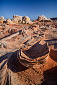 Eroded Navajo sandstone formation in the White Pocket Recreation Area, Vermilion Cliffs National Monument, Arizona. Lollipop Rock is in the background.