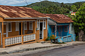 Two colorful houses with rusty corrugated metal roofs in the Barahona Province in rural Dominican Republic.
