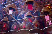 Burning incense coils send prayers to heaven in the Man Mo Temple, a Buddhist temple in Hong Kong, China.