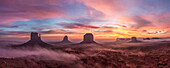 Colorful sunrise with ground fog in the Monument Valley Navajo Tribal Park in Arizona.