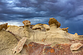 Sandstone caprocks on hoodoos in the colorful clay hills in the badlands of the San Juan Basin in New Mexico.