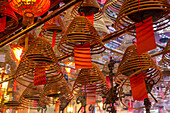 Burning incense coils send prayers to heaven in the Man Mo Temple, a Buddhist temple in Hong Kong, China.