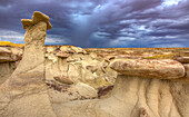 Sandstone caprocks on hoodoos in the colorful clay hills in the badlands of the San Juan Basin in New Mexico.