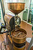 A machine for processing cacao beans to make chocolate on a cacao plantation tour. Dominican Republic.