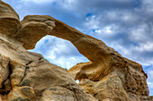 Blue sky and clouds over Graceful Arch in a remote desert near Aztec in northwestern New Mexico.