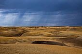 Summer storm over the colorful clay hills in the badlands of the San Juan Basin in New Mexico.