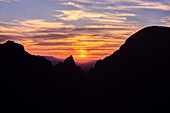 A colorful sunset at the Window in the Chisos Mountains in Big Bend National Park in Texas.