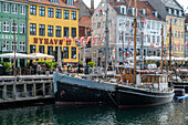 Colorfull facade and old ships along the Nyhavn Canal in Copenhagen Denmark