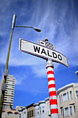 Waldo street sign painted with red stripes in San Francisco, California.