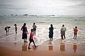 Big family on the beach at Hikkaduwa, Sri Lanka