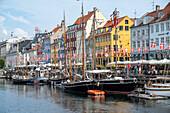 Colorfull facade and old ships along the Nyhavn Canal in Copenhagen Denmark