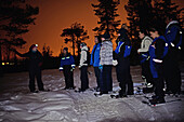 Snowshoeing at sunset through wilderness of Rovaniemi, with Safartica.