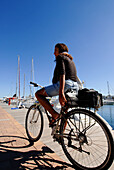 Young brazilian woman in her bike, La Savina, Formentera