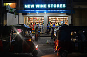 People buying at New wine stores at night in Weligama, Sri Lanka