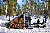 Rest and fire in a wooden refuge. Wilderness husky sledding taiga tour with Bearhillhusky in Rovaniemi, Lapland, Finland