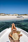 Woman relaxing on yacht in Espalmador, a small island located in the North of Formentera, Balearic Islands, Spain