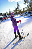 Young woman practicing Altai Skiing in Pyha ski resort, Lapland, Finland