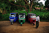 Three tuk tuks and driver, Sri Lanka