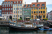 Colorfull facade and old ships along the Nyhavn Canal in Copenhagen Denmark