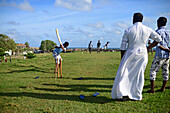 Young men playing amateur cricket game in UNESCO World Heritage, Galle Fort, during Binara Full Moon Poya Day.